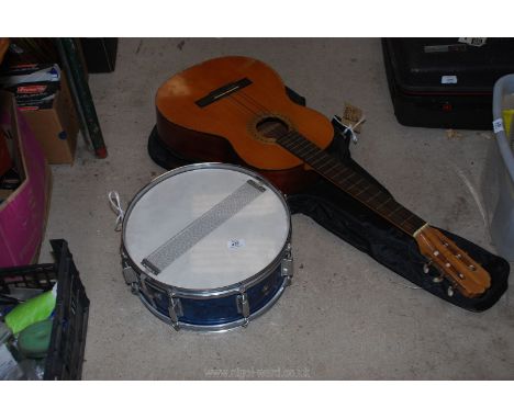 A Spanish acoustic Almeria Guitar and a spare drum.