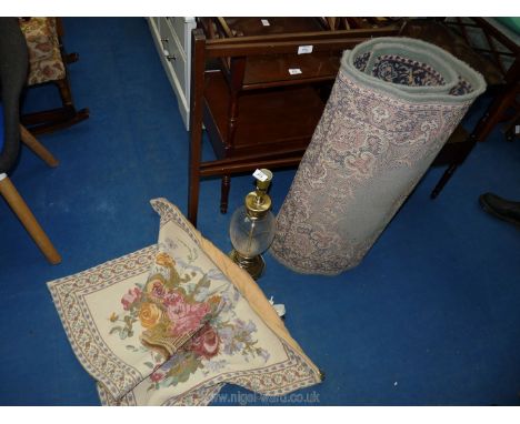 A wooden towel rail, glass table lamp, wall hanging and 2 rugs.