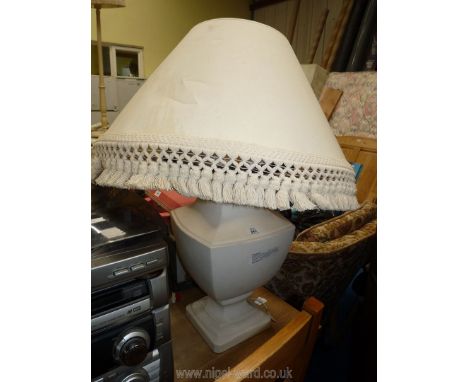 A large cream table lamp and shade.