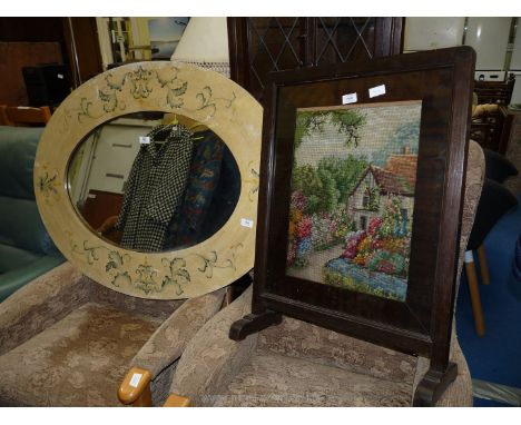 A large wooden framed oval Mirror, 41'' x 31 1/2', and a tapestry firescreen.
