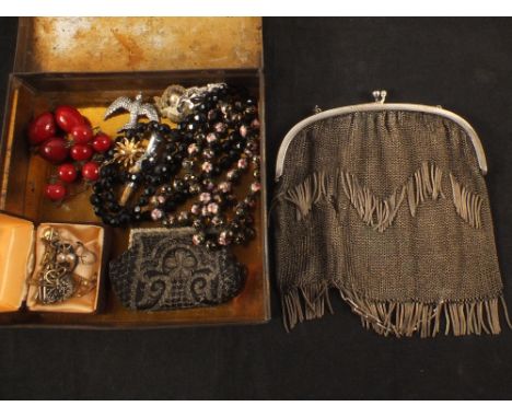 A vintage tin with contents including Art Deco chain mail purse, bead necklaces etc