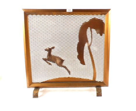 An Art Deco gilt metal running deer and tree decorated fire screen