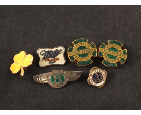 A silver Bentley pin badge in the form of Bentley logo with green enamel centre bearing letter B plus other pin badges