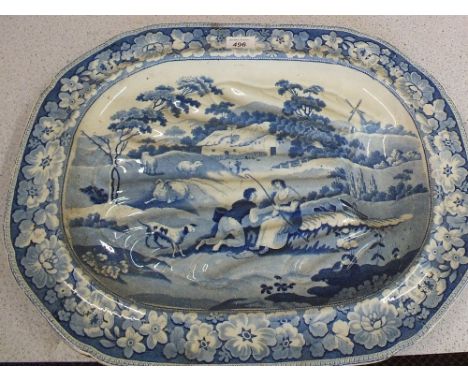 A Victorian blue and white well and tree meat plate with shepherd and shepherdess decoration (light cracks)
