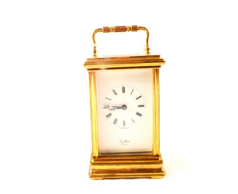 A brass carriage clock with white enamel dial, 11 jewel key wind movement, stamped St James