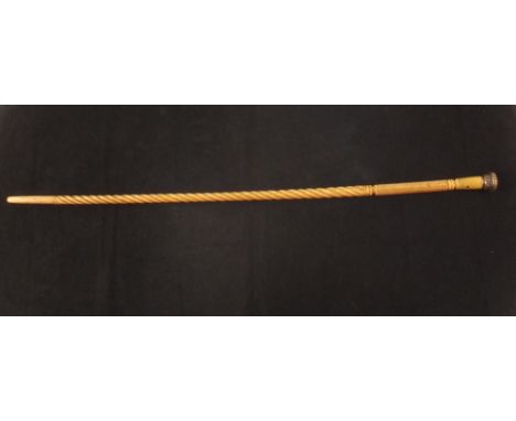 A 19th Century carved whale bone walking stick with later collar and white metal grip, length 33"