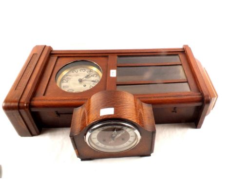 An oak cased 8 day mantel clock plus an oak cased wall hanging 8 day clock