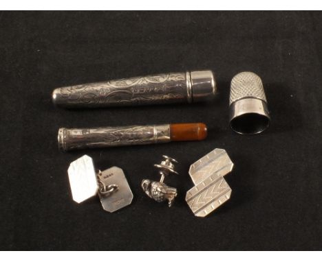 A silver tie pin in the form of a bird, a pair of silver cufflinks with engine turned decoration, a silver thimble plus two s