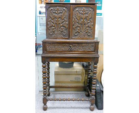 Antique carved oak two door cabinet on stand: The two doors open to reveal 10 marquetry inlaid internal drawers &amp; cupboar