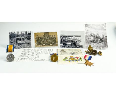 A group of medals awarded to Gnr T.W.Bailey R.G.A: Three first world war medals together with photographs, cap badges and sil