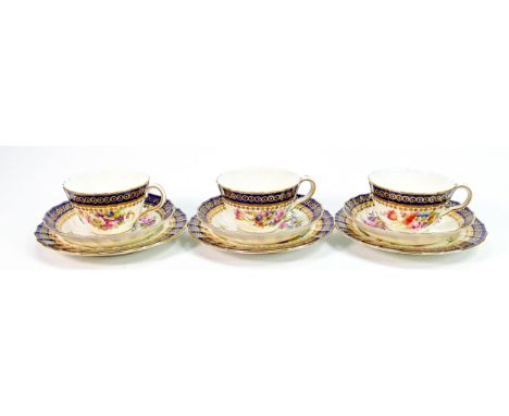 Three Royal Worcester gilded floral cups &amp; saucers and plates: Hand painted trios with flowers by E Phillips, saucer diam
