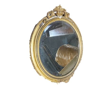 Gilt and gesso framed oval wall mirror, a Best Lloyd urn-shaped table lamp&nbsp;with relief drape decoration and a modern tab