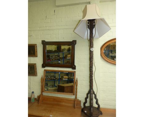 Oriental carved hardwood triform standard lamp and shade and an oak framed bevelled wall mirror (2)