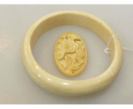 Carved ivory pendant and ivory bangle