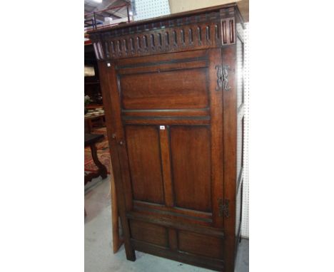 A 20th century oak wardrobe with panelled door.