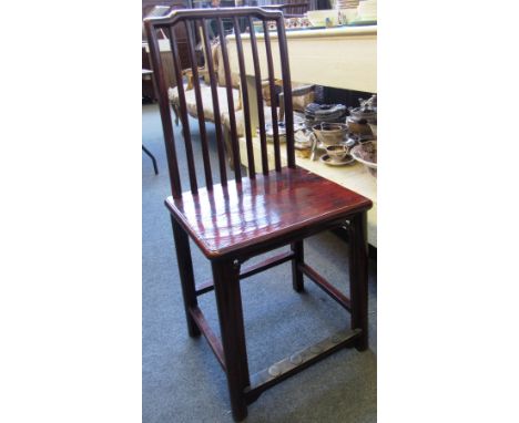 A set of four early 20th century Chinese red lacquer stick back chairs with brass capped front stretchers.