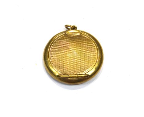A lady's 9ct gold circular pendant powder compact, with engine turned decoration, fitted with a mirror within, gross weight 1