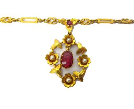A gold, seed pearl and synthetic ruby set pendant necklace, in an oval design, decorated with a floral and foliate border and