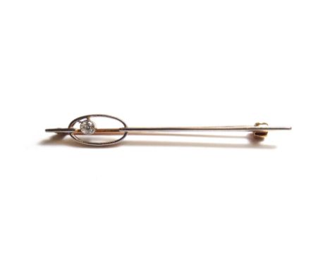 A diamond set platinum fronted and gold bar brooch, mounted with a single cushion shaped diamond, within an oval surround on 