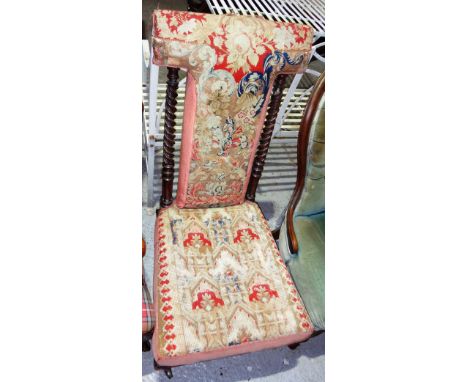 A 19th century mahogany framed prie dieu with tapestry upholstery.