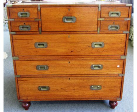 A 19th century teak two part campaign chest of five short over three long drawers, on screw off bun feet with retailers disc 