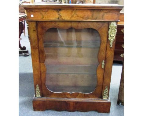 A Victorian gilt metal mounted figured walnut pier cabinet, the single glazed door on shaped plinth base, 84cm wide.