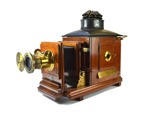 An Edwardian mahogany cased magic lantern, 'The British', by J. T. Chapman (converted to electricity), and a quantity of glas