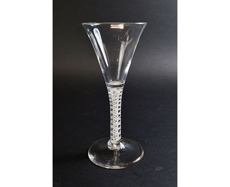 An  English wine glass, circa 1760, with drawn trumpet bowl and double series opaque twist stem, on a circular foot, 16.5cm h