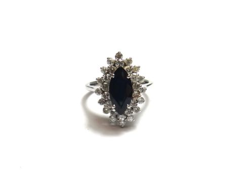 A white gold, sapphire and diamond set marquise shaped cluster ring, claw set with the marquise shaped sapphire at the centre