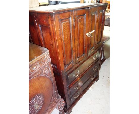 A 20th century oak TV cabinet with three drawers, on bracket feet. 