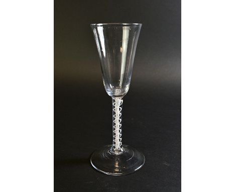 An English wine glass, circa 1760, with ogee bowl and double series opaque twist stem, on a circular foot, 18cm high.  Illust