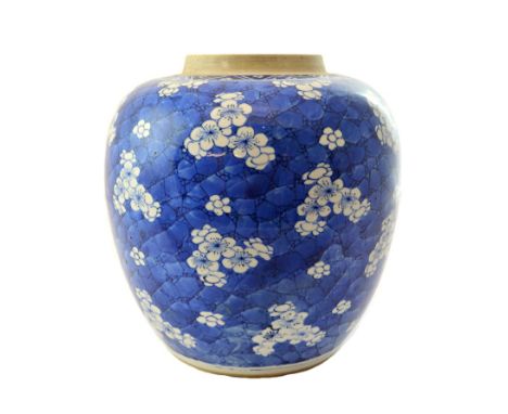 A Chinese blue and white ovoid jar, Kangxi, painted with prunus blossom against a `cracked ice' ground, 21cm.high.  Illustrat