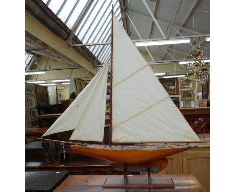 A vintage wooden pond yacht, 'Eileen', with stained wooden hull and lead keel, on a mahogany base, 97cm wide x 106cm high ove