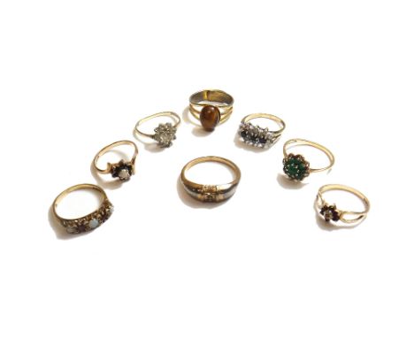 A 9ct gold, opal and red gem set five stone ring, a 9ct gold, sapphire and colourless gem set triple cluster ring, a 9ct gold