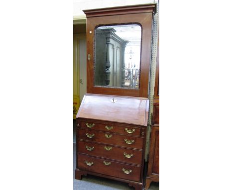 A small George III mahogany bureau bookcase, the single mirror door over a fitted interior, four long graduated drawers, on b