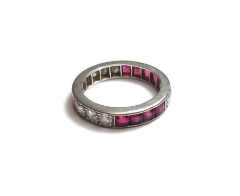 A ruby and diamond set full eternity ring, mounted with three rows of four square cut rubies, alternating with three rows of 