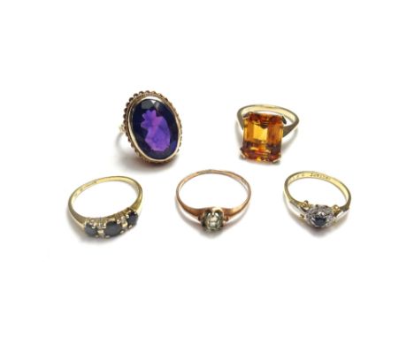 A 9ct gold ring, collet set with an oval cut amethyst, a 9ct gold ring, claw set with a rectangular step cut citrine, a gold 