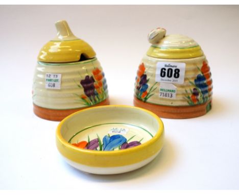 A Clarice Cliff 'Beehive' preserve pot and cover, circa 1930, decorated in the 'Crocus' pattern with a moulded bee finial to 