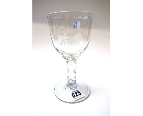 An  English wine glass, circa 1780, the large ogee bowl presentation engraved and dated 1815, on a facet cut stem and circula