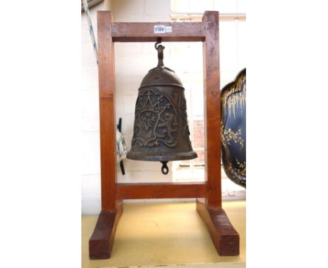 A reproduction bronze bell held in a wooden frame, 20th century, relief cast with the Dutch East India Companies 'VOC' monogr