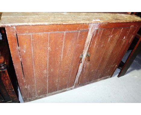 A 19th century scumbled pine two door side cabinet of tongue and groove construction.