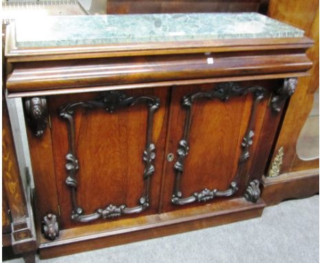 A Victorian rosewood side cabinet, the rectangular marble top over cushion frieze drawer and pair of doors, on plinth base, 1