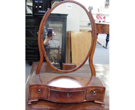 An early 19th century inlaid mahogany toilet mirror with serpentine three drawer base, on ogee bracket feet, 44cm wide. 