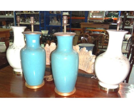 A pair of blue glaze ceramic lamp bases and a pair of white glaze lamp bases.