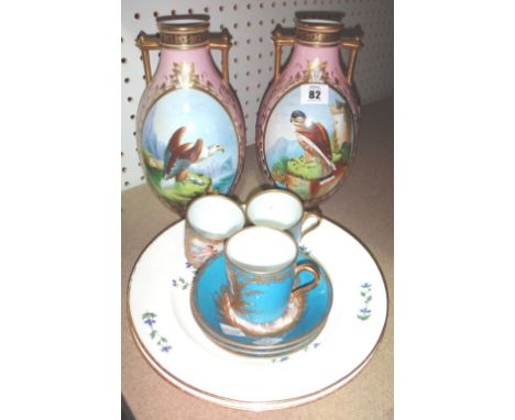 A pair of ceramic twin handled vases, painted with birds, three Sevres style cups and saucers and a pair of floral painted pl