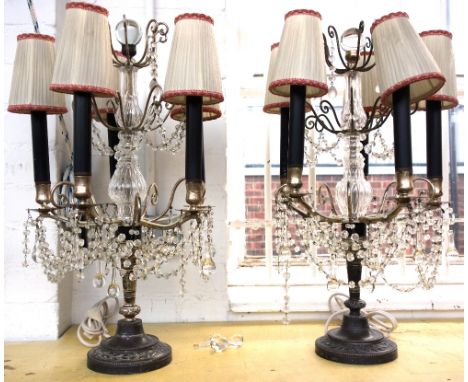 A pair of silvered metal and glass mounted five branch table lamp candelabra, each hung with chains of glass beads, (with ple