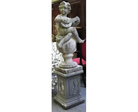 A pair of reconstituted stone figures of seated cherubs playing instruments sat on a sphere, each approximately 103cm high, t