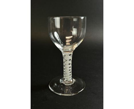 An English wine glass, circa 1760, with large ogee bowl and double series opaque twist stem, on a circular foot, 15.5cm high.