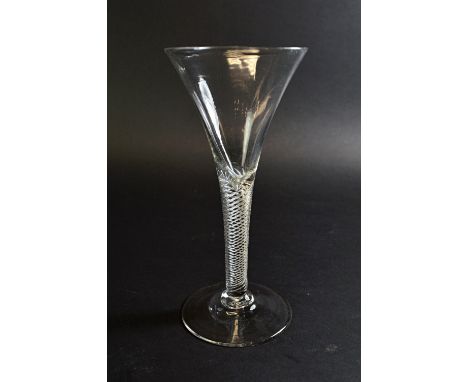 An English wine glass, mid 18th century, with drawn trumpet bowl and multi series air twist stem, on a circular foot, 18.3cm 