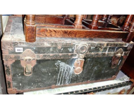 A 20th century black tin Naval trunk and another trunk.
